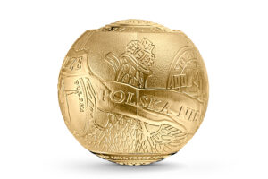 Detal złotej monety w kształcie kuli